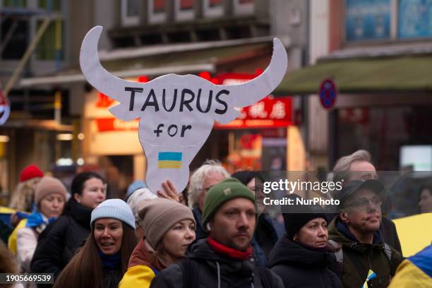 Sign of the ''Taurus missile'' is visible while hundreds of people are participating in a demonstration to show support for Ukraine, where a...