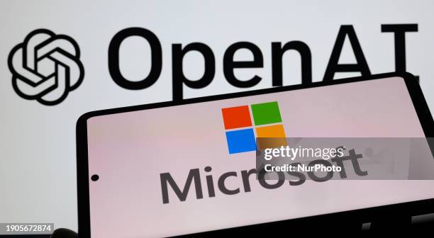 The Microsoft logo is being displayed on a smart phone, with the OpenAI logo visible on the screen in the background, in this photo illustration...