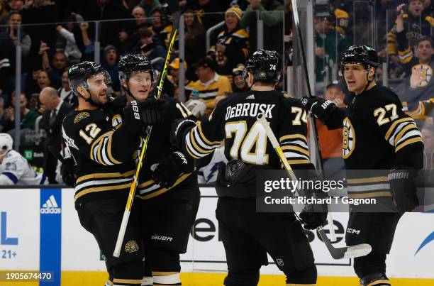 Trent Frederic of the Boston Bruins celebrates with his teammates Kevin Shattenkirk, Jake DeBrusk and Hampus Lindholm after he scored against the...