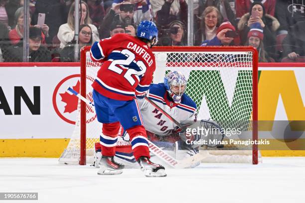 Cole Caufield of the Montreal Canadiens shoots the puck past goaltender Jonathan Quick of the New York Rangers during the shootout at the Bell Centre...