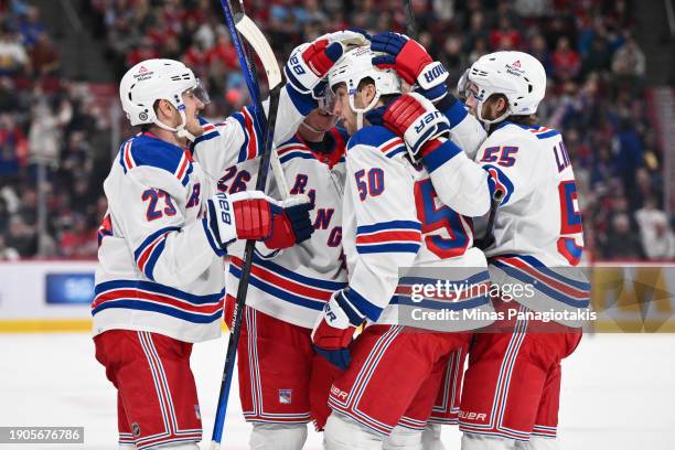 Adam Fox of the New York Rangers celebrates his goal with teammates Jimmy Vesey, Will Cuylle and Ryan Lindgren during the third period against the...