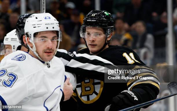 Trent Frederic of the Boston Bruins shoves Michael Eyssimont of the Tampa Bay Lightning during the third period at the TD Garden on January 6, 2024...