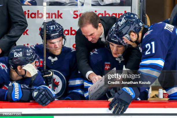 Associate coach Scott Arniel of the Winnipeg Jets discusses strategy with players Vladislav Namestnikov, Nikolaj Ehlers, Morgan Barron, and Dominic...