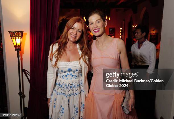 Isla Fisher and Rosamund Pike at The Golden Eve Party held at Chateau Marmont on January 6, 2024 in Los Angeles, California.