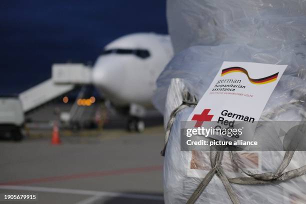 January 2024, Saxony, Schkeuditz: Relief supplies stand on the apron at Leipzig-Halle Airport. A plane is taking off from there on Sunday for...