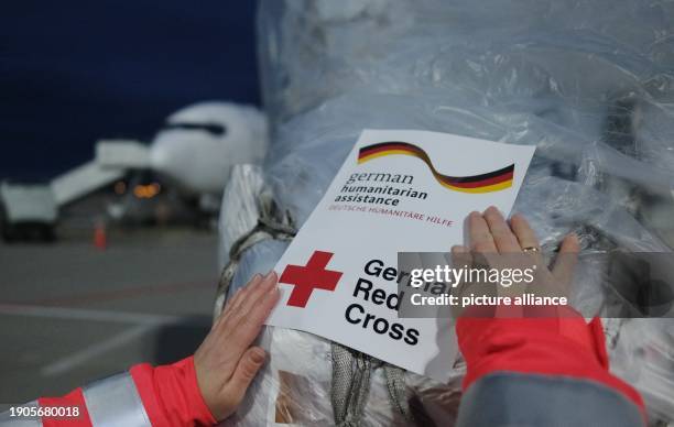 January 2024, Saxony, Schkeuditz: Relief supplies are marked with a sticker at Leipzig-Halle Airport. A plane takes off from Aiporz on Sunday for...
