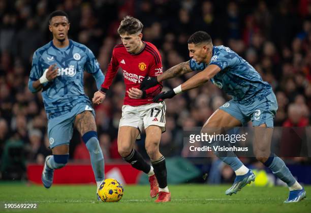 Alejandro Garnacho of Manchester United in action with Diego Carlos and Ezri Konsa of Aston Villa in action during the Premier League match between...