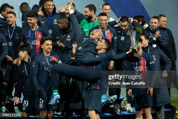 Goalkeeper Keylor Navas - holding the trophy -, Achraf Hakimi, Marquinhos, Carlos Soler, Marco Asensio, Fabian Ruiz Pena and teammates celebrate...