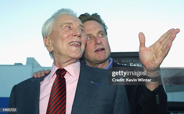 Actor Kirk Douglas and son producer/actor Michael Douglas arrive at the premiere of "It Runs In The Family" at the Bruin Theater on April 7, 2003 in...