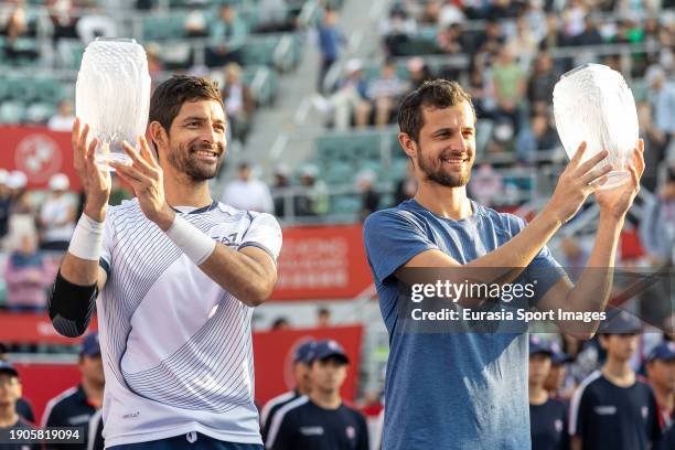 Mens doubles winners Mate Pavic of Croatia and Marcelo Arevalo of El Salvador pose for photo with trophy after the mens doubles final match on day...