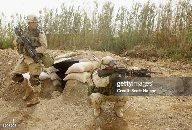 Army 3rd Division 3-7 infantry soldier Corporal Edwin Garcia from Los Angeles, CA provides cover as Sergeant Matthew Gadzalinski from Milwaukee, WI,...
