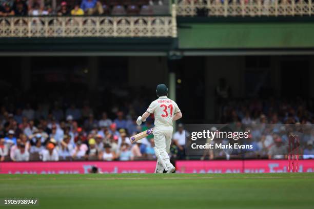 David Warner of Australia walks off after being caught out by Babar Azam of Pakistan off the bowling of Salman Ali Agha of Pakistan during day two of...