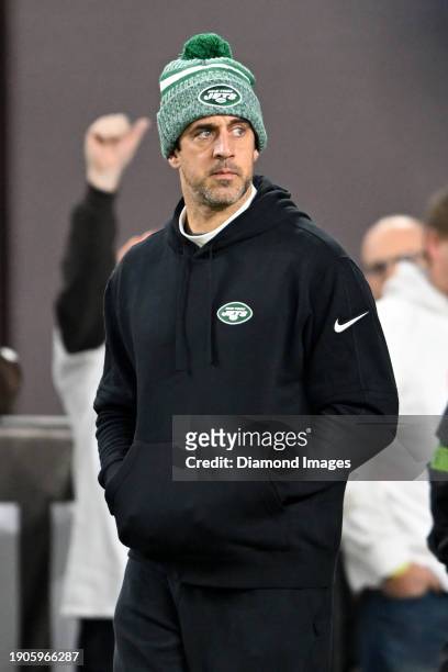 Aaron Rodgers of the New York Jets walks onto the field prior to a game against the Cleveland Browns at Cleveland Browns Stadium on December 28, 2023...