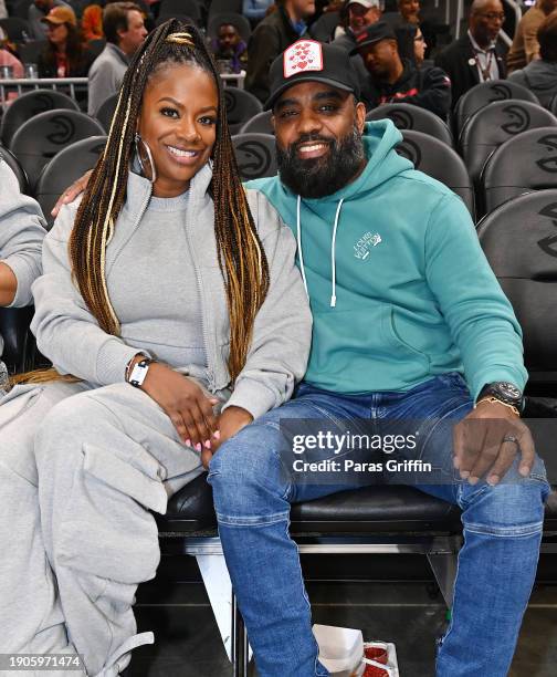 Kandi Burruss and Todd Tucker attend the game between the Oklahoma City Thunder and the Atlanta Hawks at State Farm Arena on January 03, 2024 in...