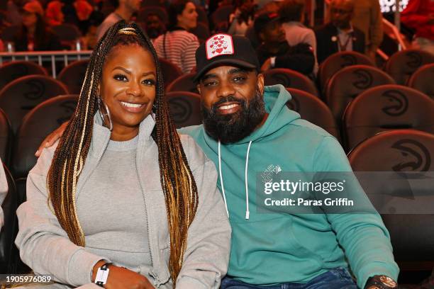 Kandi Burruss and Todd Tucker attend the game between the Oklahoma City Thunder and the Atlanta Hawks at State Farm Arena on January 03, 2024 in...