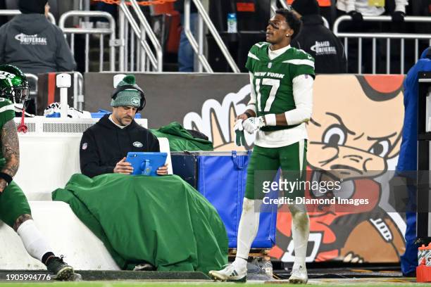 Aaron Rodgers of the New York Jets looks at a Microsoft Surface tablet during the second half against the Cleveland Browns at Cleveland Browns...
