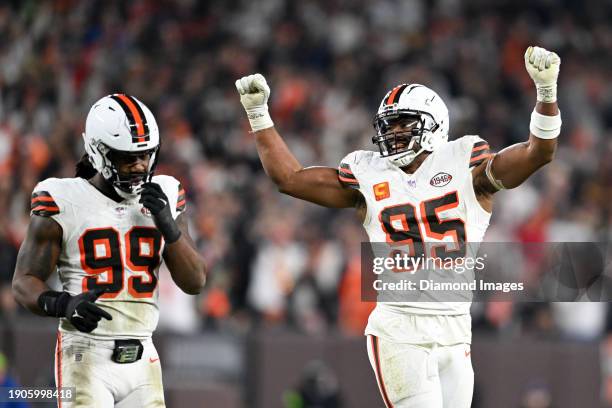 Myles Garrett and Za'Darius Smith of the Cleveland Browns celebrate a third down stop during the second half against the New York Jets at Cleveland...