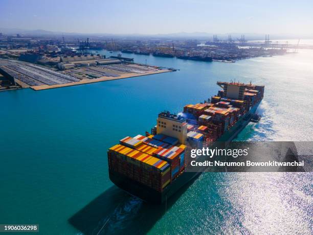 aerial view of a cargo ship in a thriving harbor - ma stock pictures, royalty-free photos & images