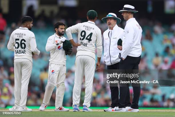 Shan Masood of Pakistan speaks with the umpires as play is suspended due to bad light during day two of the Men's Third Test Match in the series...