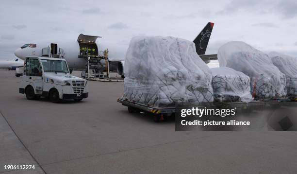 January 2024, Saxony, Schkeuditz: Relief supplies stand on the apron at Leipzig-Halle Airport. A plane is taking off from there on Sunday for...