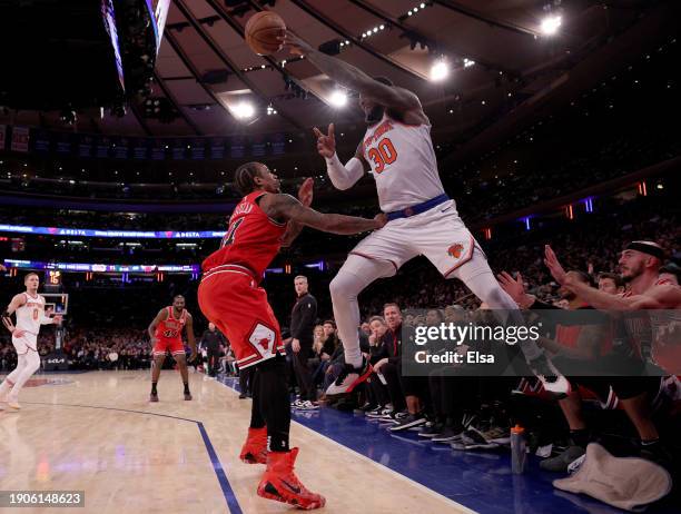 Julius Randle of the New York Knicks keeps the ball in bounds as he gets the turnover while DeMar DeRozan of the Chicago Bulls defends during the...