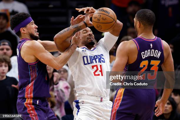 Devin Booker of the Phoenix Suns and Norman Powell of the Los Angeles Clippers battle for control of the ball during the second half at Footprint...