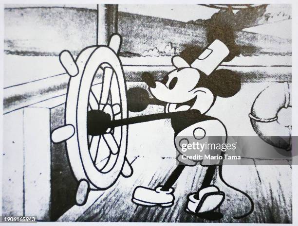 In this photo illustration, a still from Disney's 'Steamboat Willie' that was the debut of Mickey Mouse is seen in a book on January 03, 2024 in...