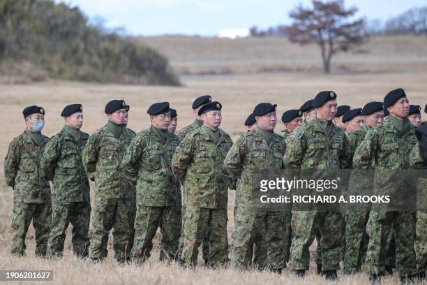 Japanese soldiers stand at attention at the end of a joint military drill and demonstration conducted by Japan's Ground Self-Defence Force 1st...