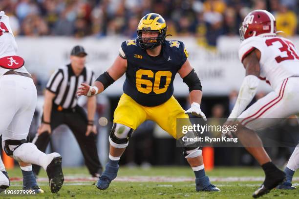 Offensive lineman Drake Nugent of the Michigan Wolverines blocks during the CFP Semifinal Rose Bowl Game against the Alabama Crimson Tide at Rose...