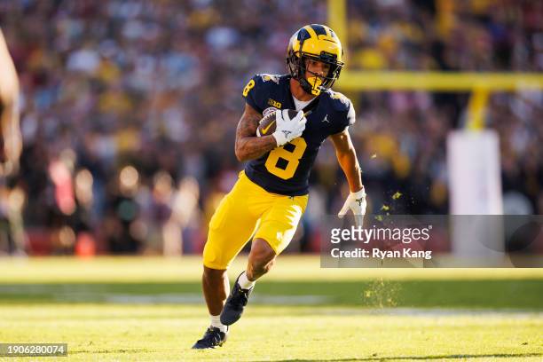 Wide receiver Tyler Morris of the Michigan Wolverines runs the ball on his way to score a touchdown during the CFP Semifinal Rose Bowl Game against...