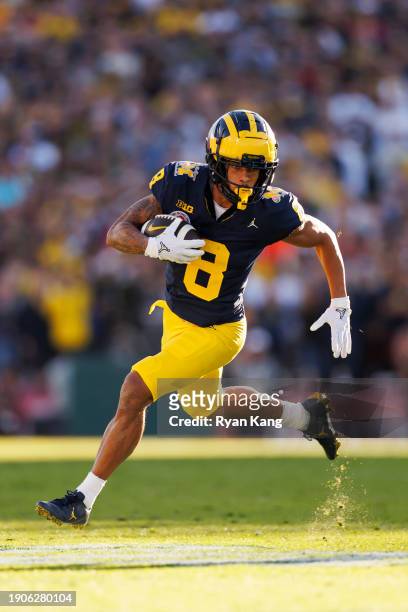 Wide receiver Tyler Morris of the Michigan Wolverines runs the ball on his way to score a touchdown during the CFP Semifinal Rose Bowl Game against...