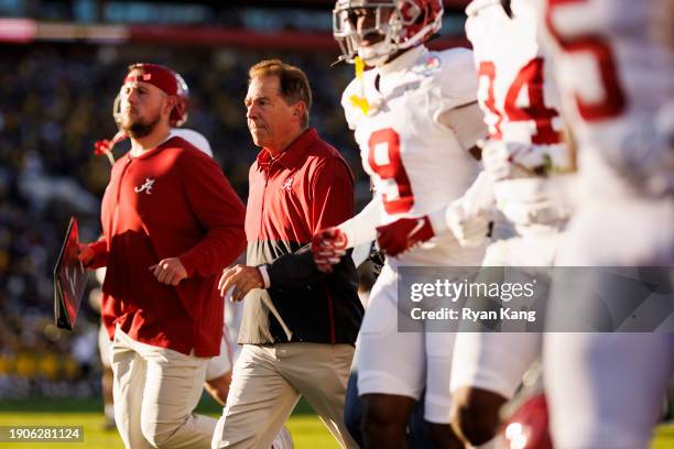 Head coach Nick Saban of the Alabama Crimson Tide runs off the field at halftime during the CFP Semifinal Rose Bowl Game against the Michigan...