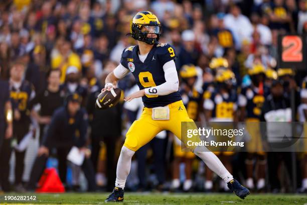 Quarterback J.J. McCarthy of the Michigan Wolverines looks to throw a pass during the CFP Semifinal Rose Bowl Game against the Alabama Crimson Tide...