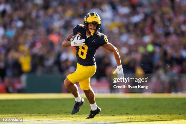 Wide receiver Tyler Morris of the Michigan Wolverines runs the ball on his way to score a touchdown during the CFP Semifinal Rose Bowl Game against...