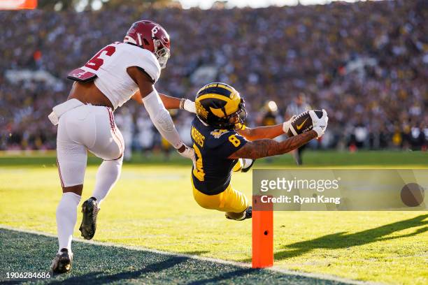 Wide receiver Tyler Morris of the Michigan Wolverines dives for the pylon to score a touchdown during the CFP Semifinal Rose Bowl Game against the...