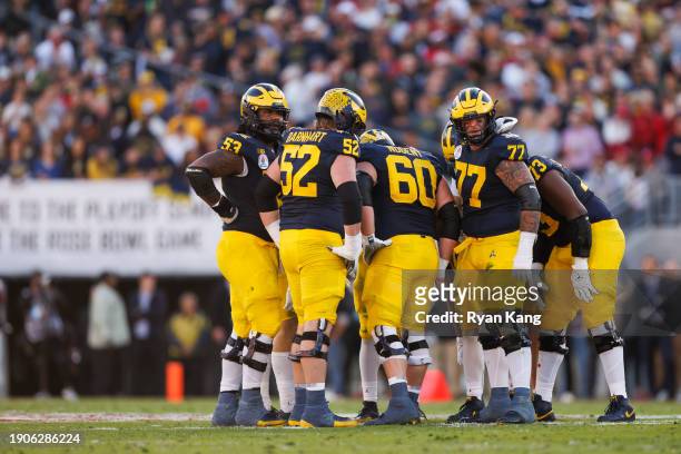 The Michigan Wolverines huddle on offense during the CFP Semifinal Rose Bowl Game against the Alabama Crimson Tide at Rose Bowl Stadium on January 1,...