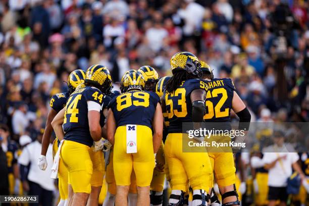 The Michigan Wolverines huddle on offense during the CFP Semifinal Rose Bowl Game against the Alabama Crimson Tide at Rose Bowl Stadium on January 1,...