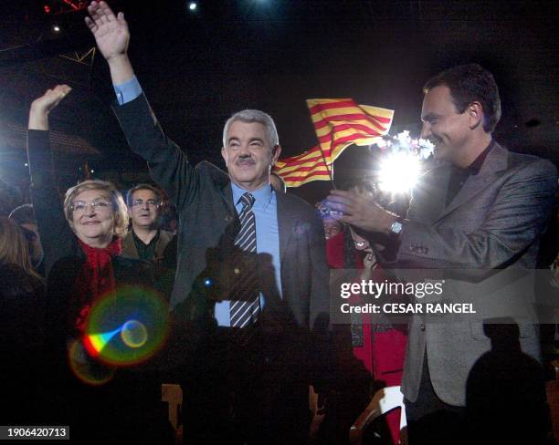 The candidate of the Catalan socialist party , Pascual Maragall , and his wife Diana Garrigosa raise ther hands, and the leader of the Spanish...