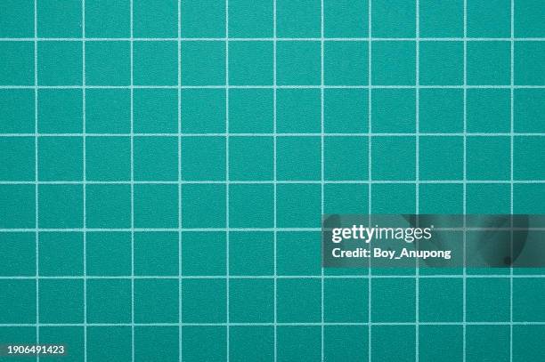 full frame shot of green cutting mat. a cutting mat is an essential piece of equipment for all crafters, artisans, and hobbyists. - cutting mat stock pictures, royalty-free photos & images