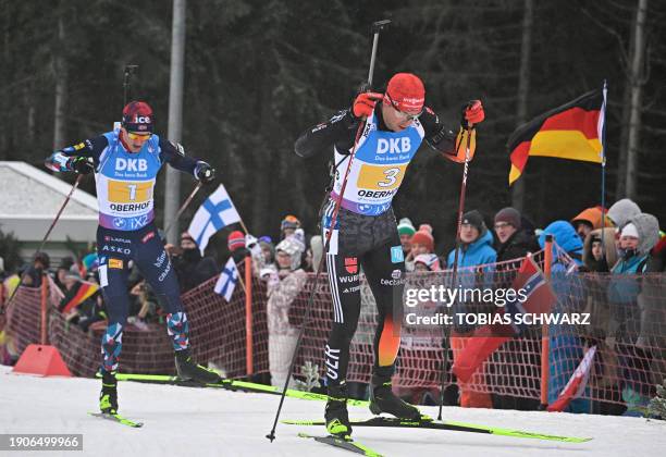 Norway's Tarjei Bo and Germany's Philipp Nawrath compete during the men's 4x 7,5km relay event of the IBU Biathlon World Cup in Oberhof, eastern...