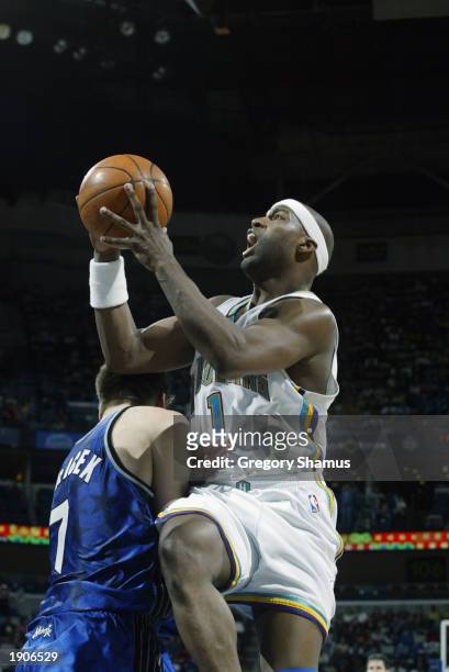 Baron Davis of the New Orleans Hornets goes up for the shot against Gordan Giricek of the Orlando Magic at New Orleans Arena on March 26 in New...