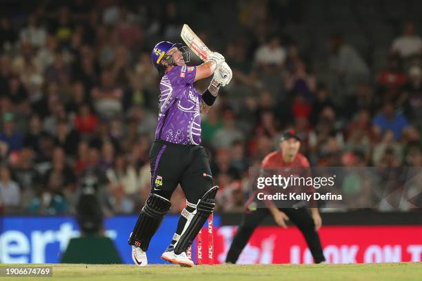 Ben McDermott of the Hurricanes hits a ball that becomes stuck in the stadium roof during the BBL match between Melbourne Renegades and Hobart...