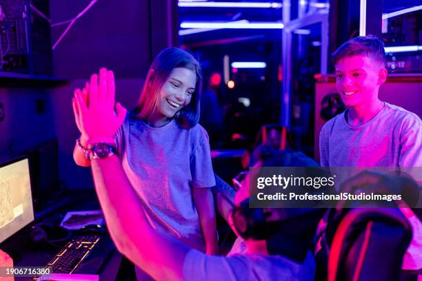 high-five in spirited esports victory - gameplay stock pictures, royalty-free photos & images