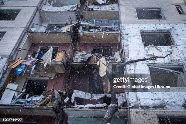 View of the destroyed facade of a residential high-rise building after a Russian missile attack on January 3, 2024 in Kyiv, Ukraine. After the...