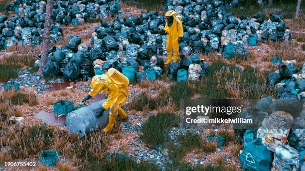 hazmat-covered workers face the frontlines of earth's destruction - miss world stock pictures, royalty-free photos & images