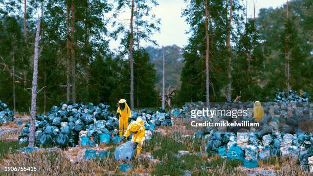 hazmat-covered workers reflect the urgency of waste management crisis - miss world stock pictures, royalty-free photos & images