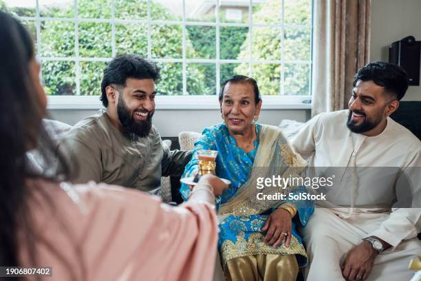 family caring for one another - ramadan giving imagens e fotografias de stock