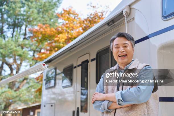 elderly, silver life, camping, camping trailer, fall, active senior, awning, solo travel, smile, happiness, arms folded [alone] - installing blinds stock pictures, royalty-free photos & images