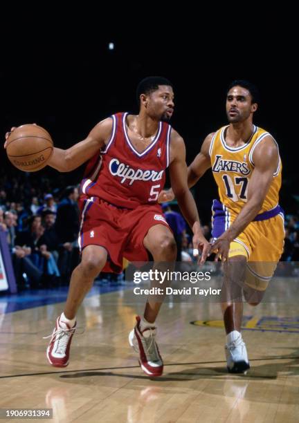 Charles Smith, Shooting Guard for the Los Angeles Clippers in motion dribbling the basketball down court past Rick Fox, Small Forward for the Los...