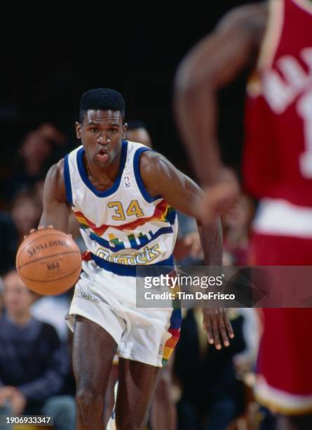 Reggie Williams, Small Forward for the Denver Nuggets in motion dribbling the basketball down court during the NBA Midwest Division basketball game...